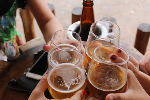 Friend cheersing their beer