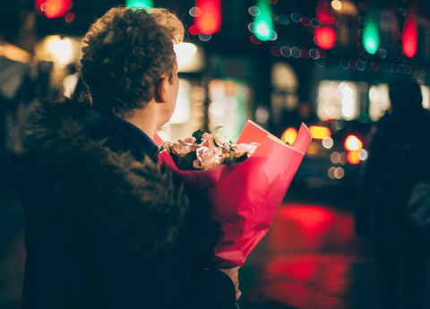A man holding a bouquet of flowers
